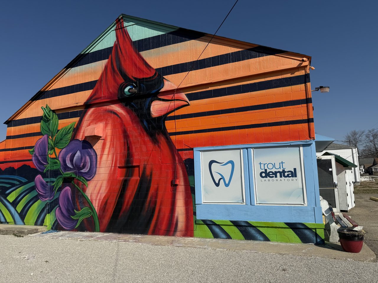 The Trout Dental Laboratory building in Fillmore, Indiana, with its hand-painted red-cardinal mural.