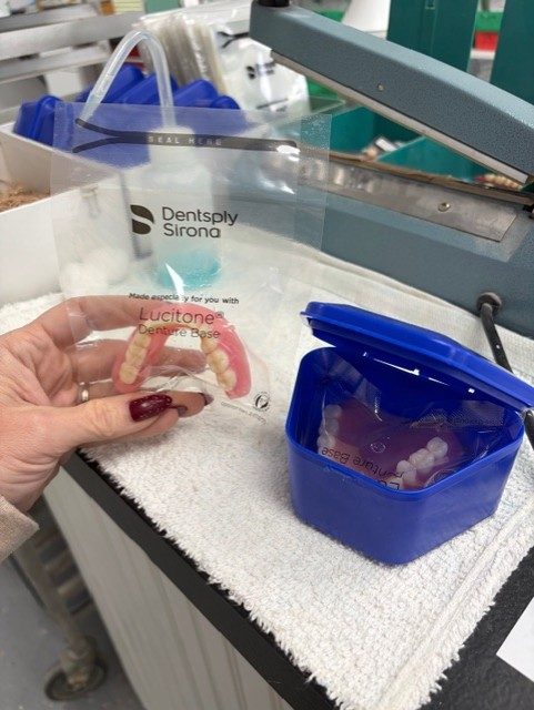 Custom dentures with a Lucitone denture base, crafted at Trout Dental Laboratory.